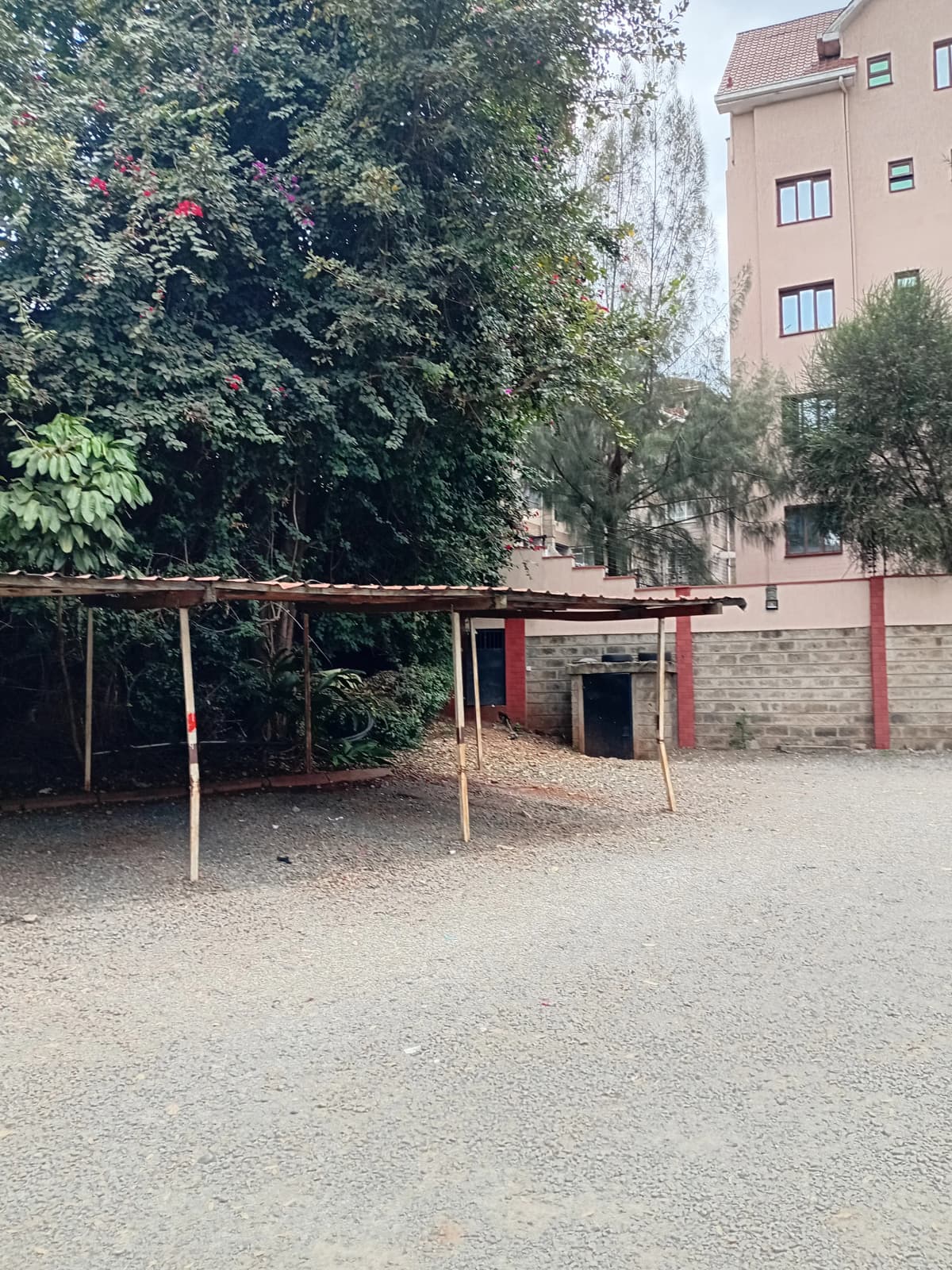 Covered parking area with metal roof structure