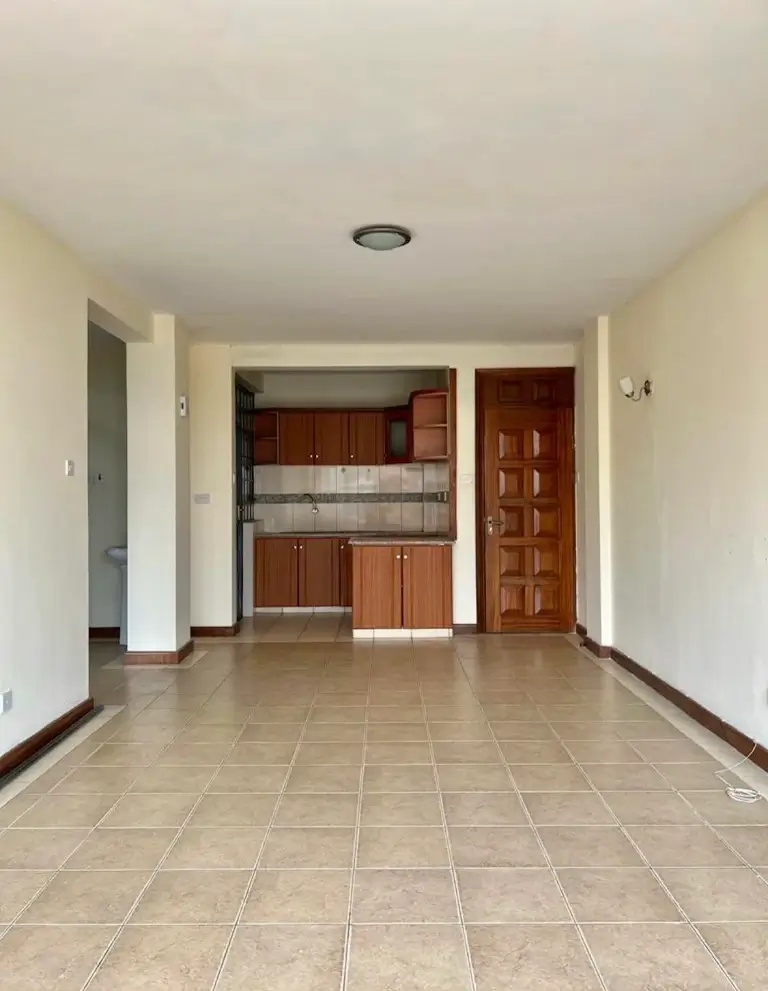 Open-plan living area with integrated kitchen unit visible