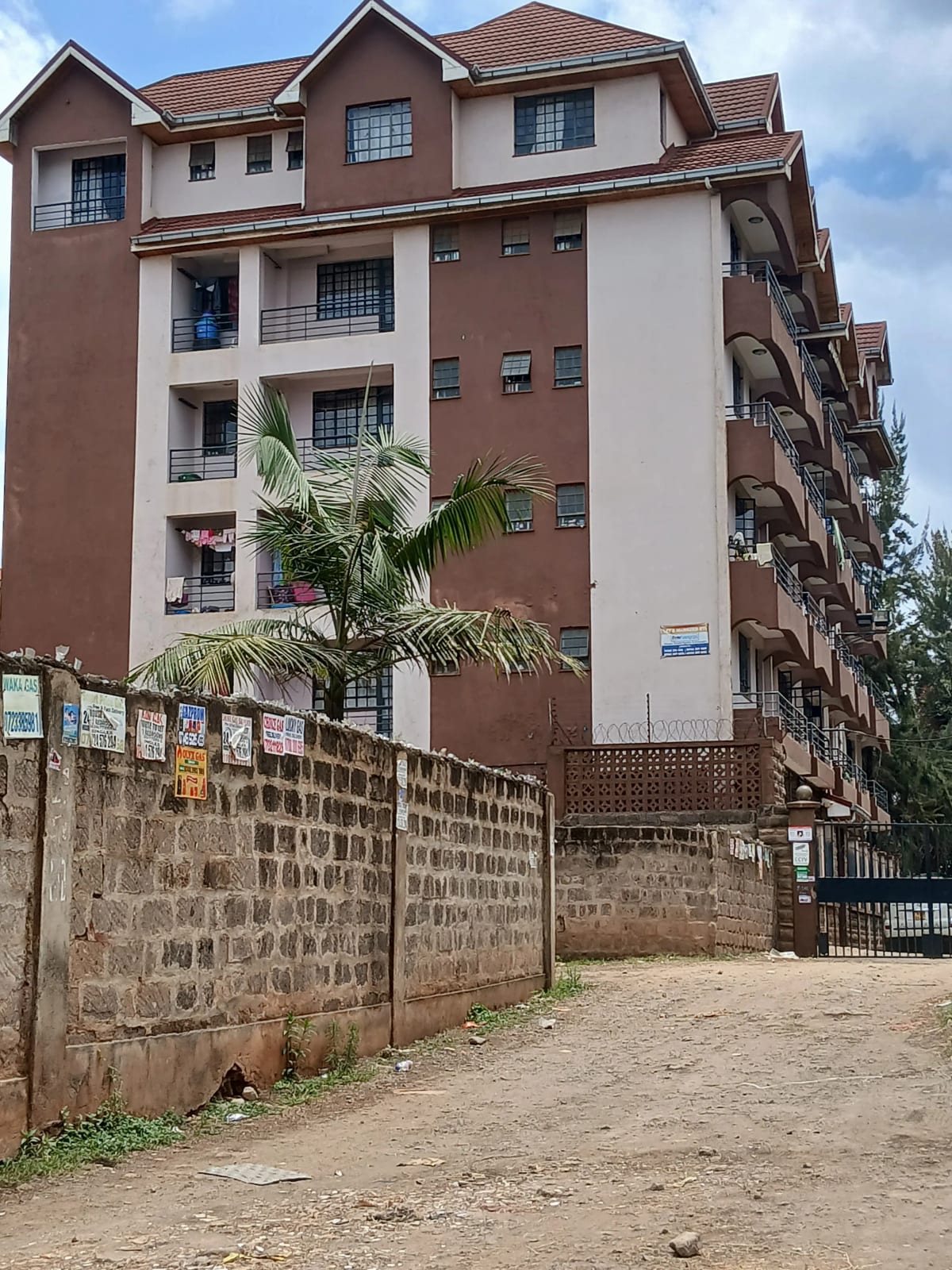 Multi-story residential building with brown and cream facade
