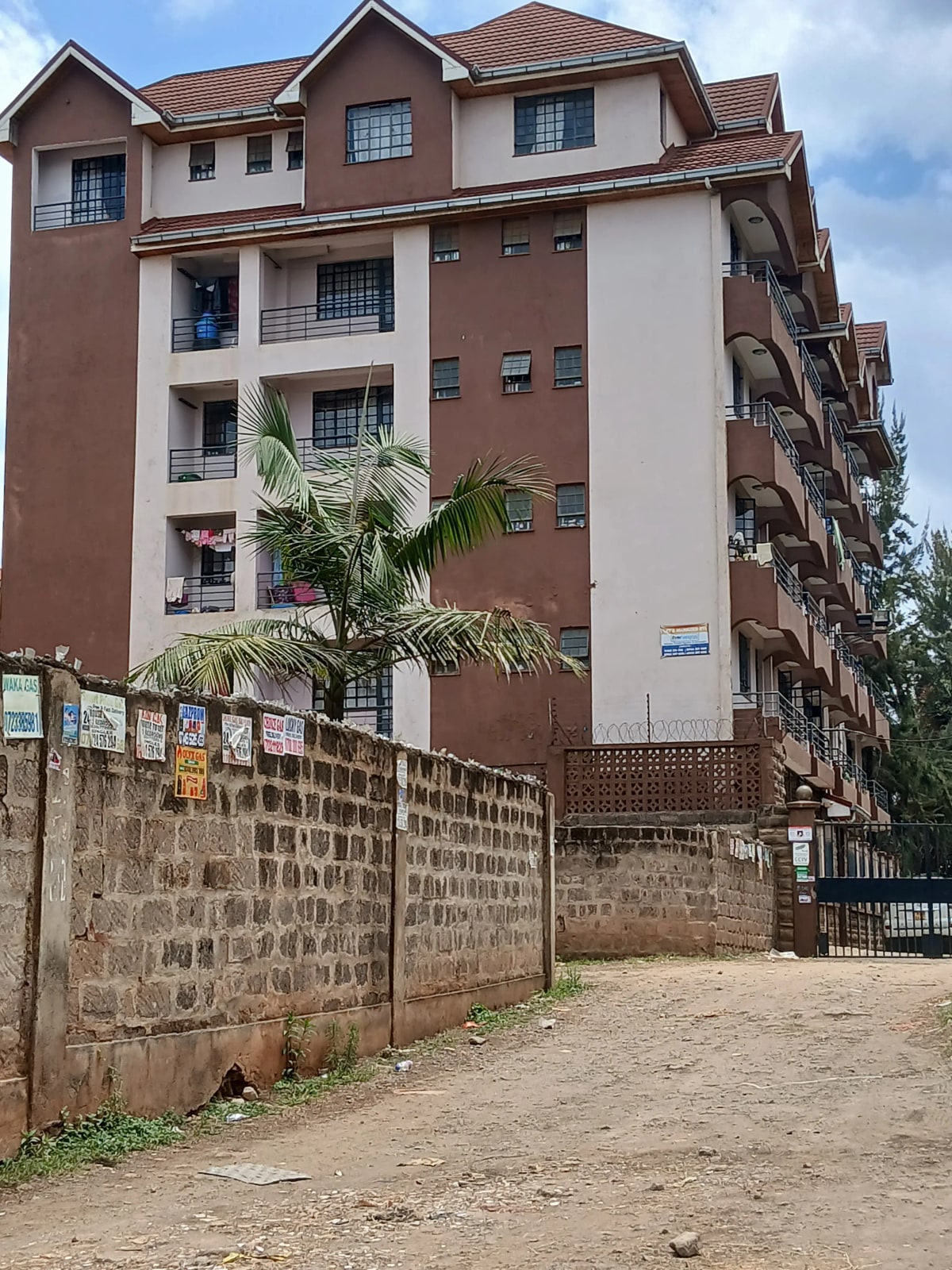 Multi-story residential building with brown and cream facade