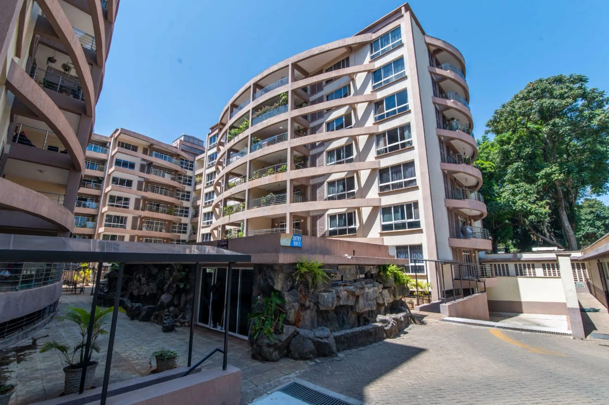 Modern multi-story residential complex with curved balconies