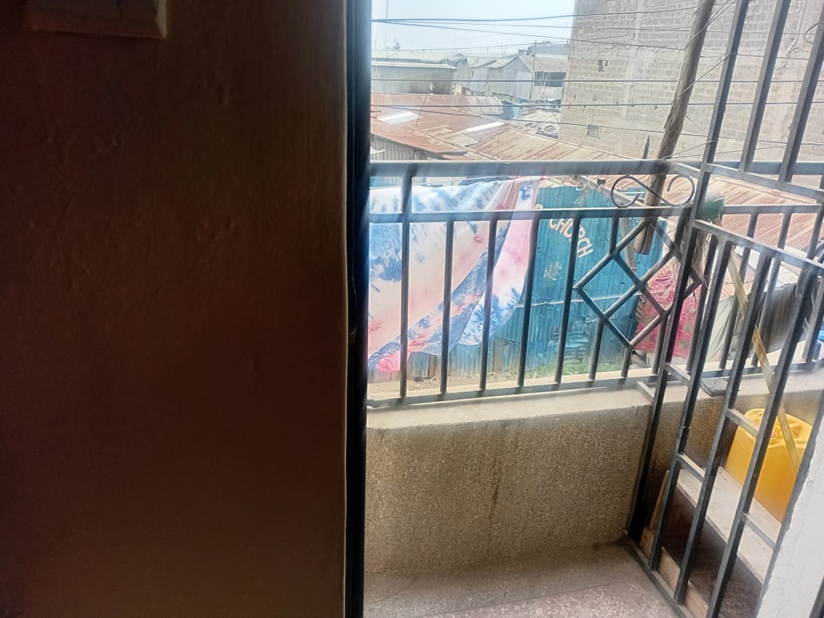 Balcony with metal railing overlooking residential compound