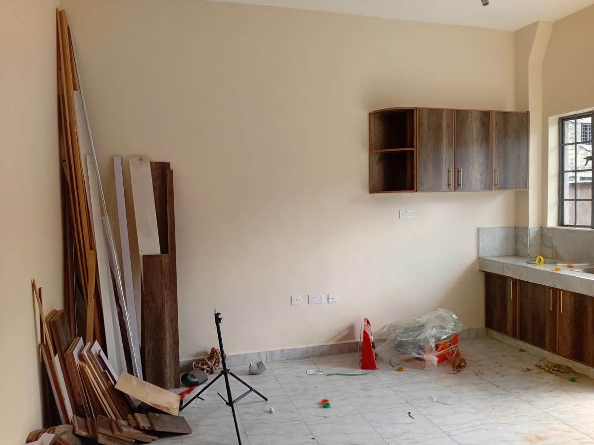 Under-construction kitchen with wooden cabinets and countertop