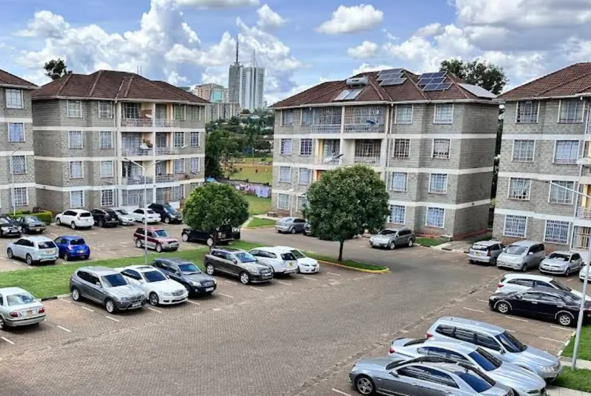 Multi-story residential complex with shared parking compound