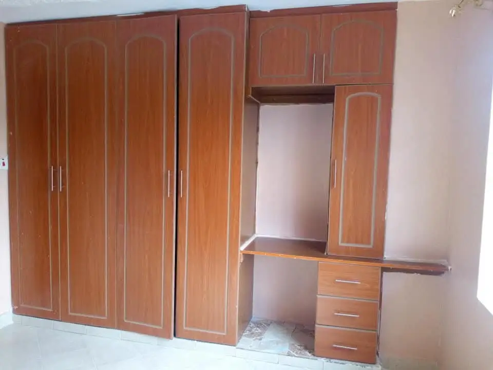 Bedroom with wooden built-in wardrobes and dressing table
