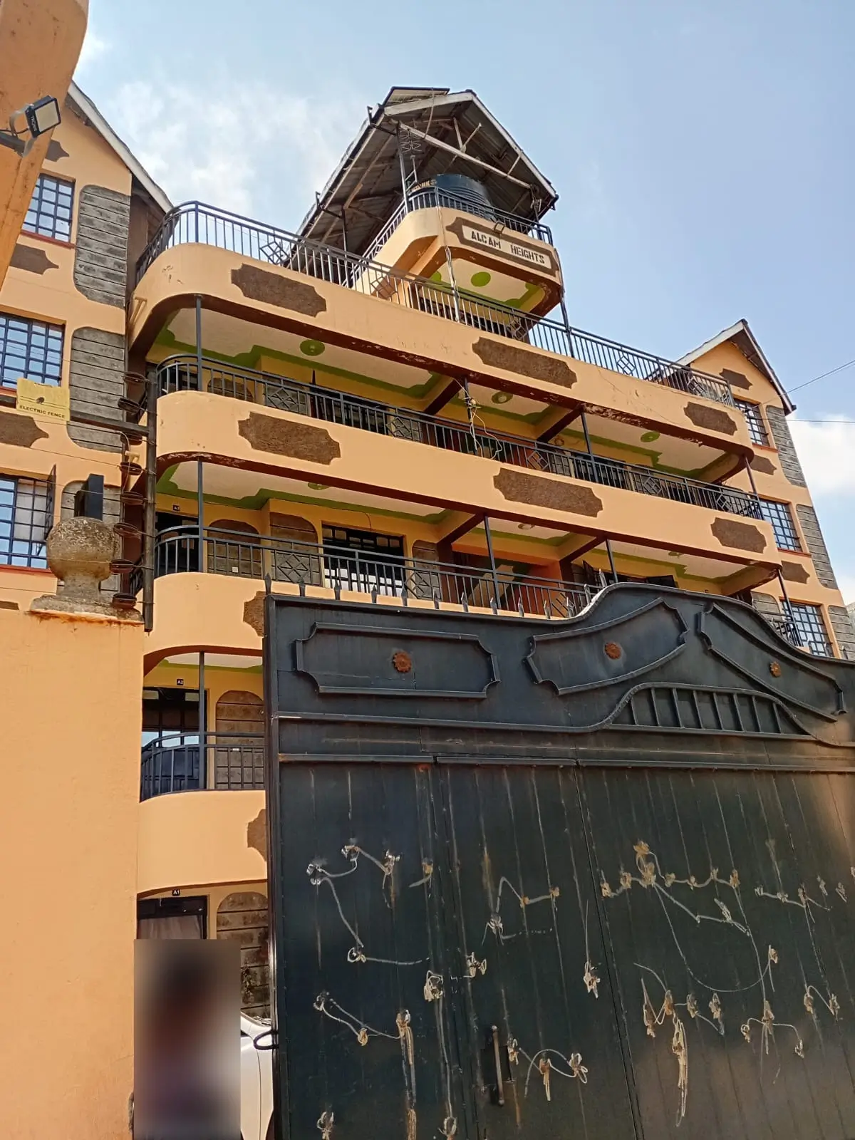 Multi-story residential building facade with balconies and tower