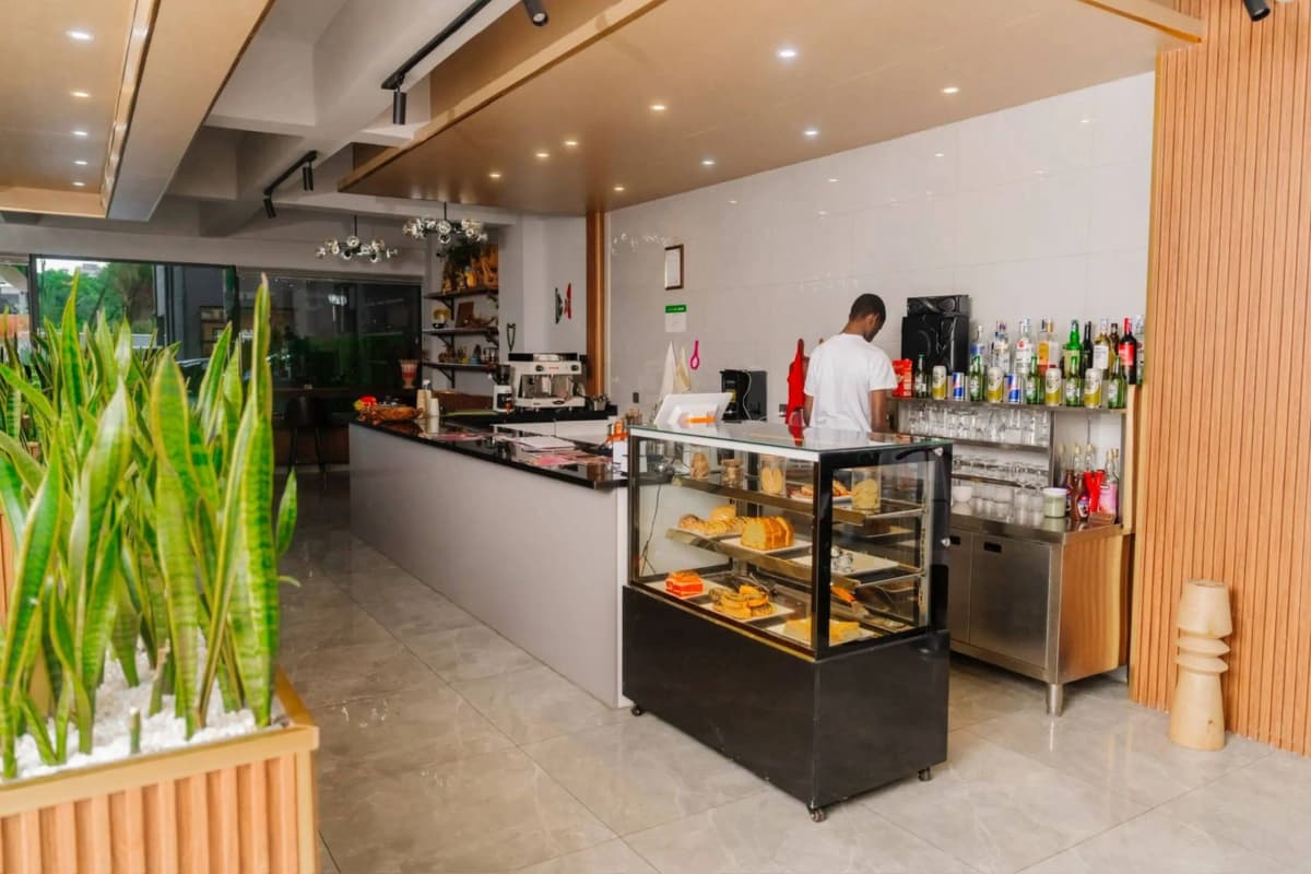Commercial café bar with pastry display and barista