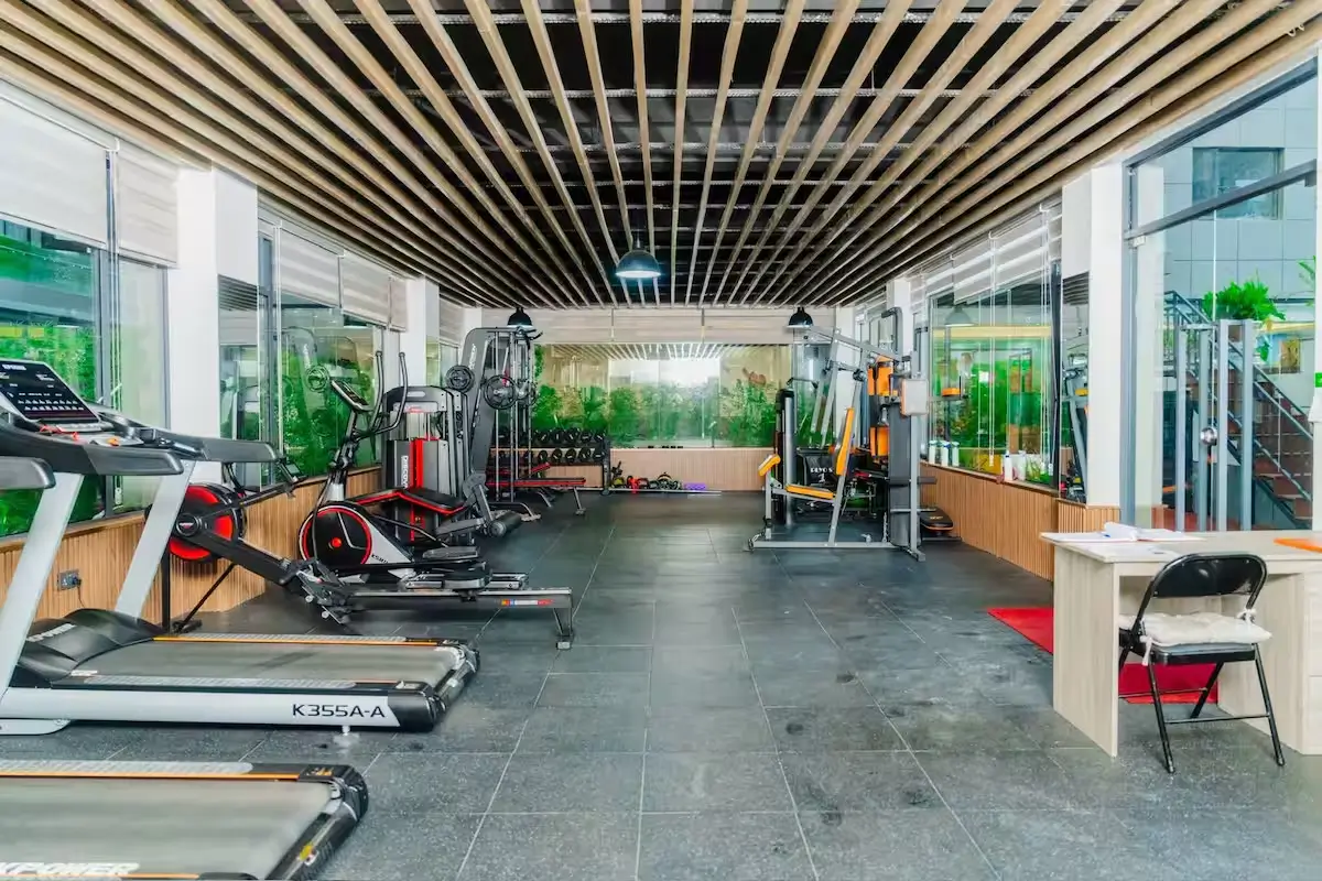 Spacious gym with treadmills, elliptical and cable machines