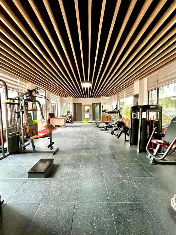 Spacious gym with wood slat ceiling and multiple machines