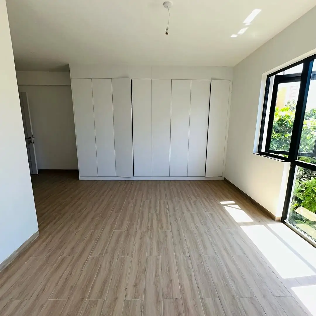 Bright bedroom with built-in wardrobe and natural light