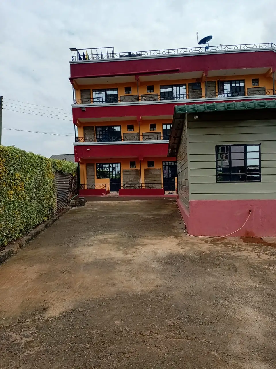 Multi-story residential building with red and yellow facade