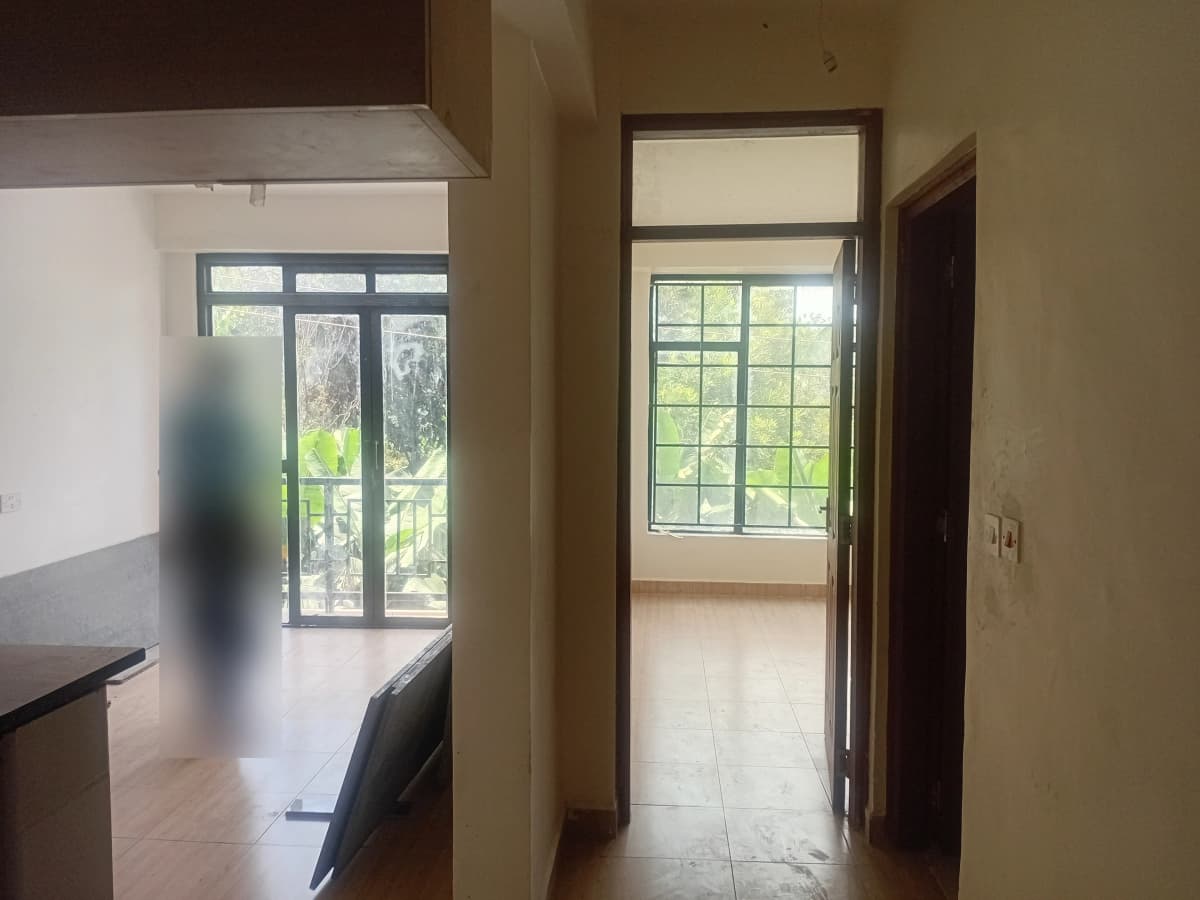 Internal corridor with large windows overlooking garden area
