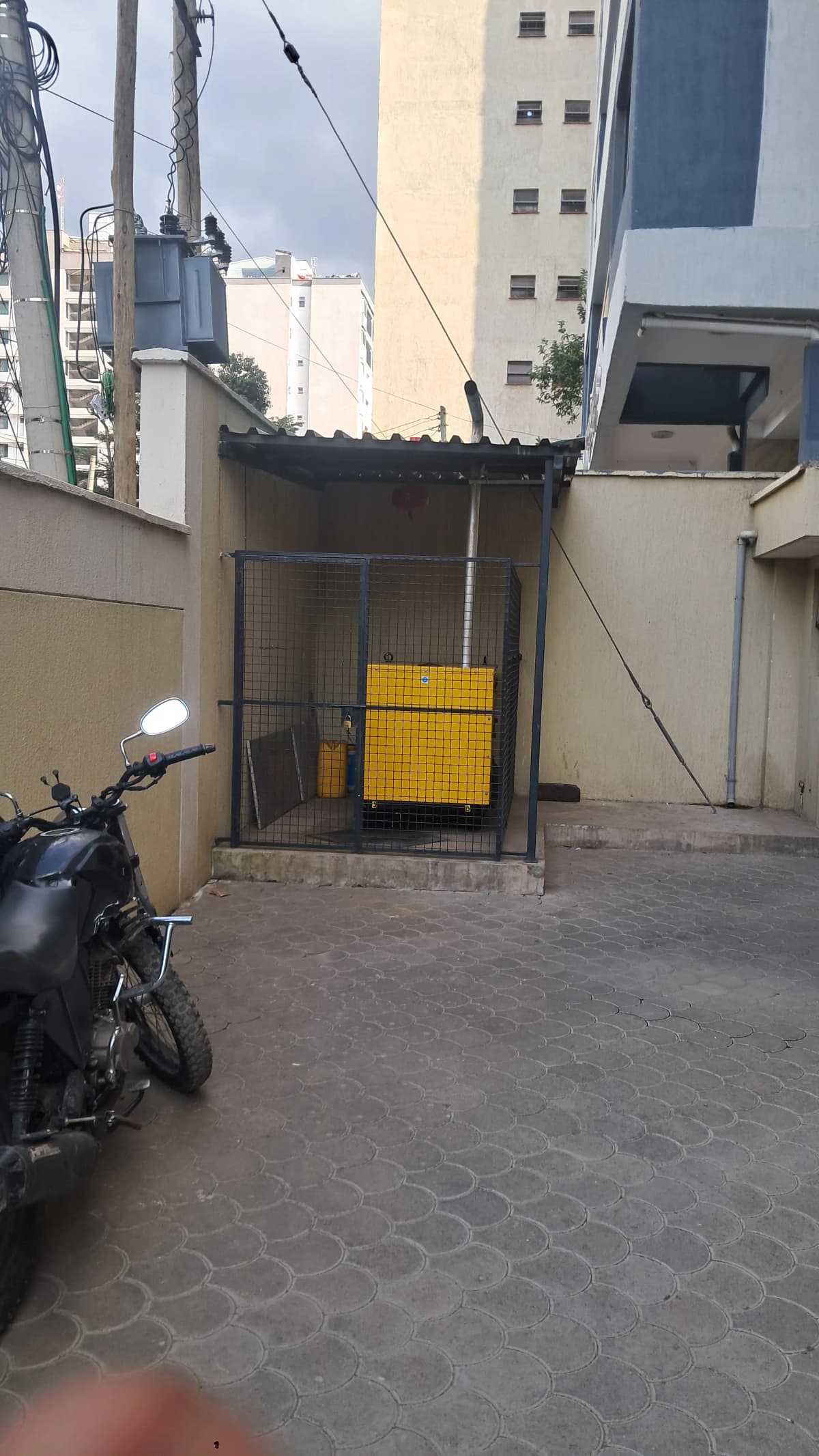 Compact parking bay with yellow gate and motorcycle