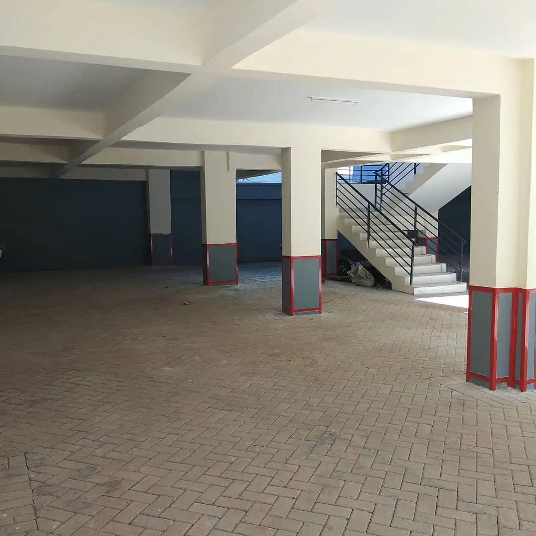 Spacious ground floor lobby with staircase and structural columns