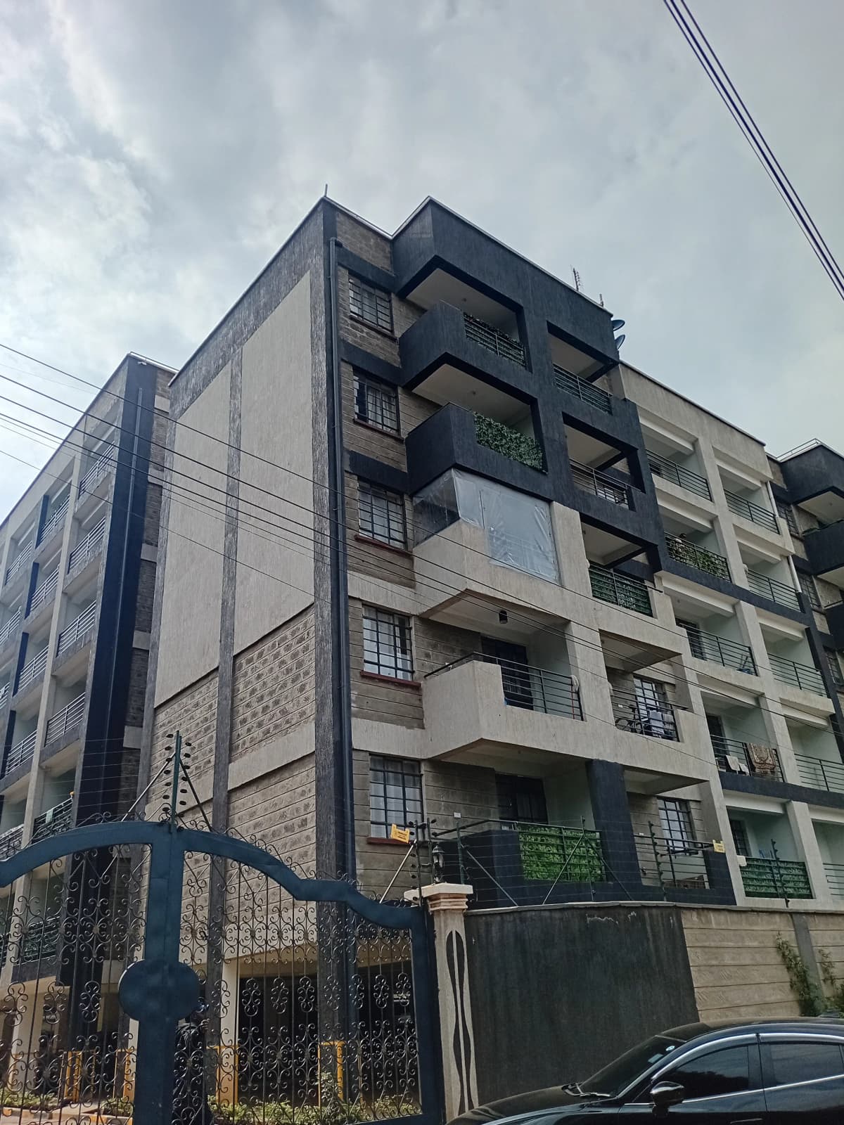 Modern multi-story residential building with balconies and street presence