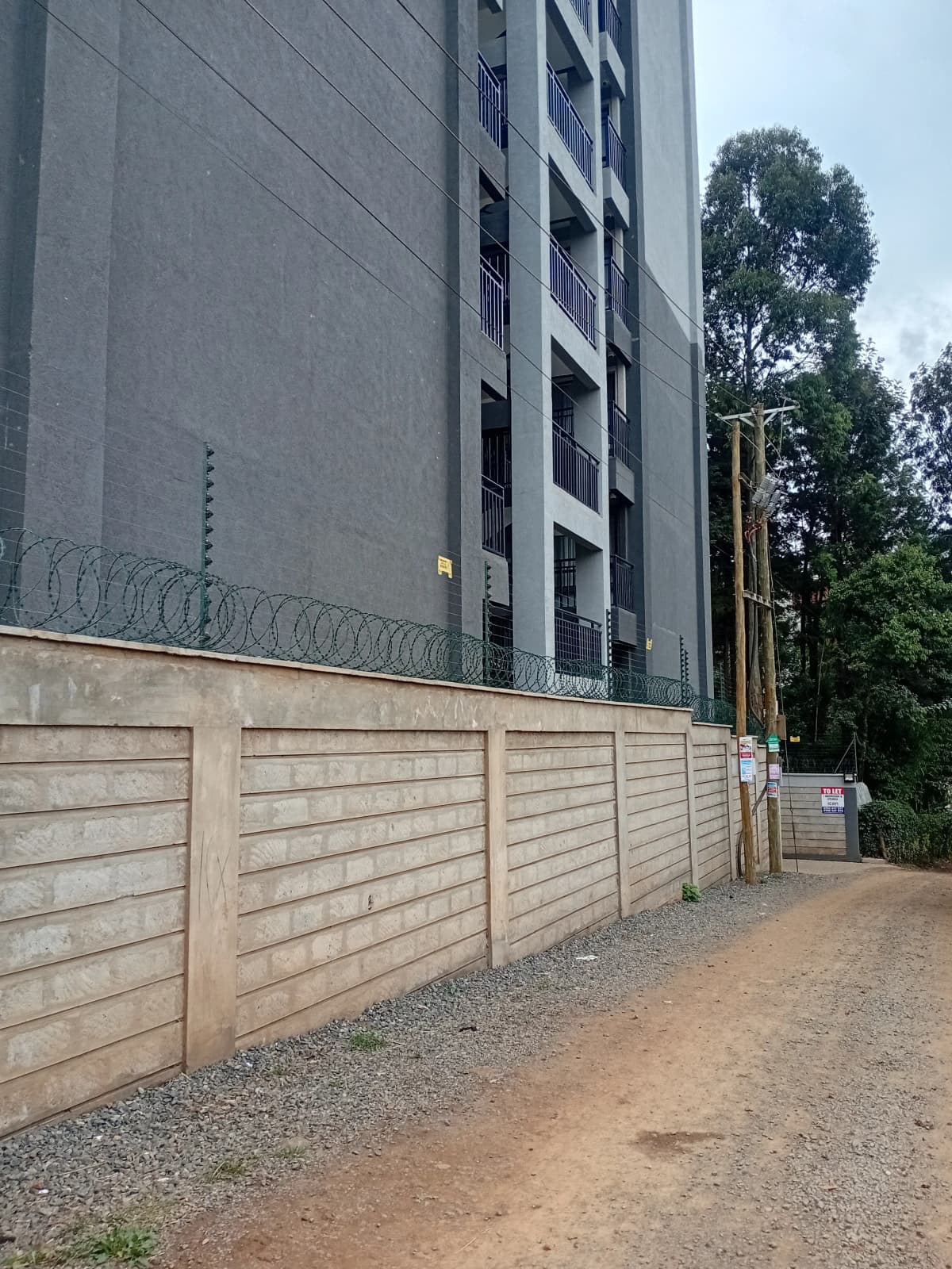 Modern residential building with perimeter fence and gate