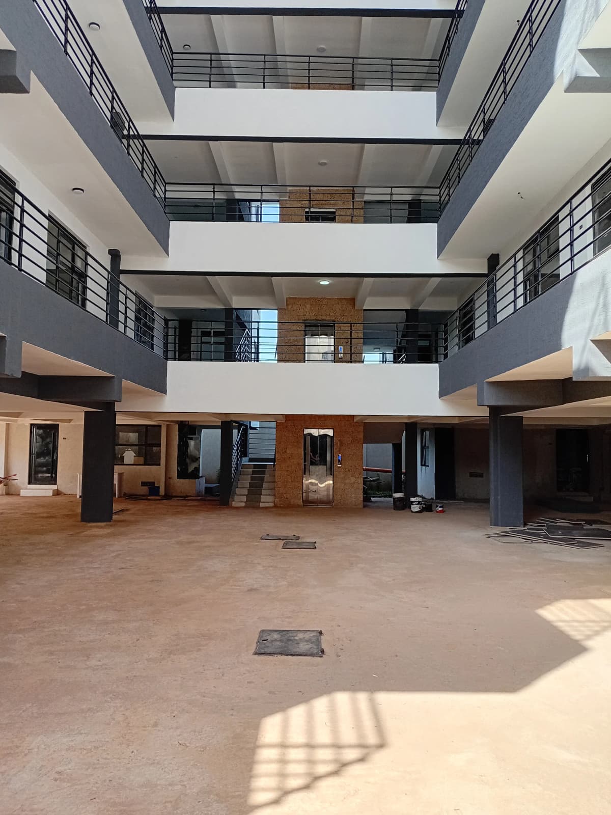 Multi-story atrium lobby with skylight and wooden accents
