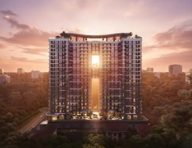 Tall luxury apartment tower at golden sunset, aerial view