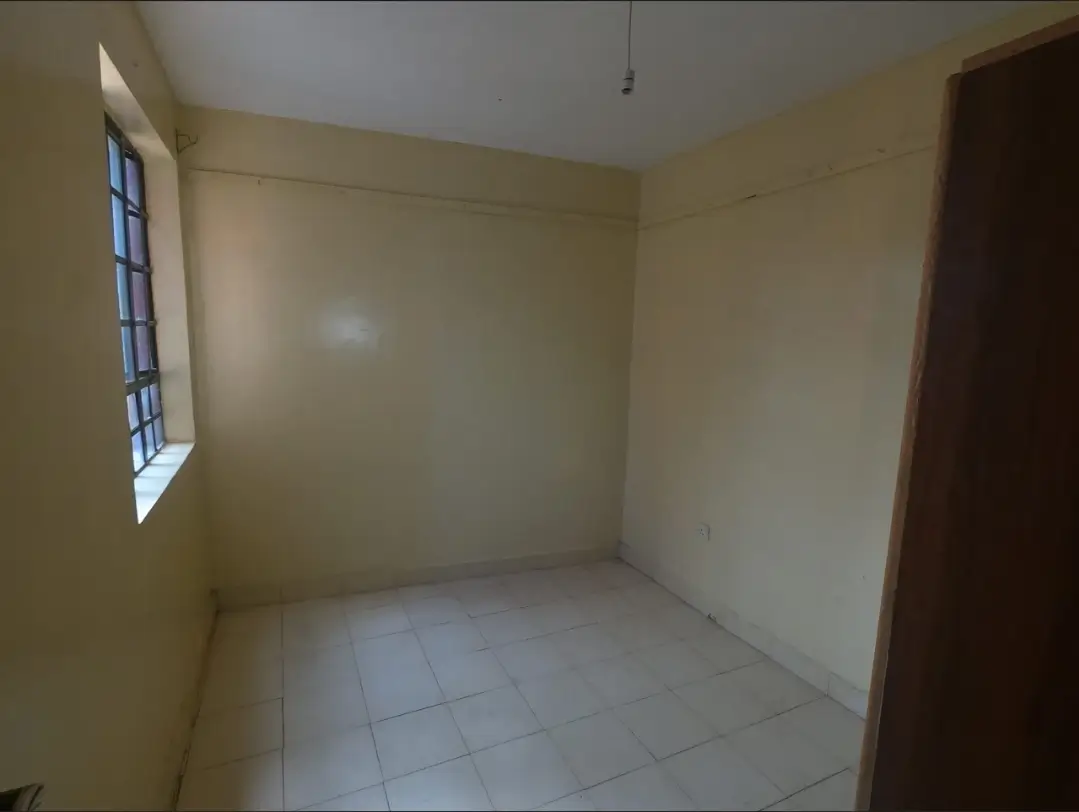 Empty bedroom with tiled floor and single window