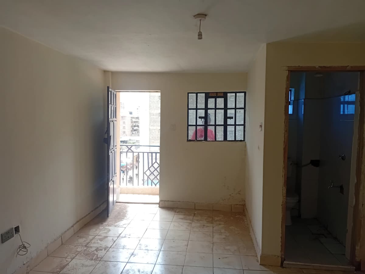 Light-filled living room with balcony access and tiled flooring