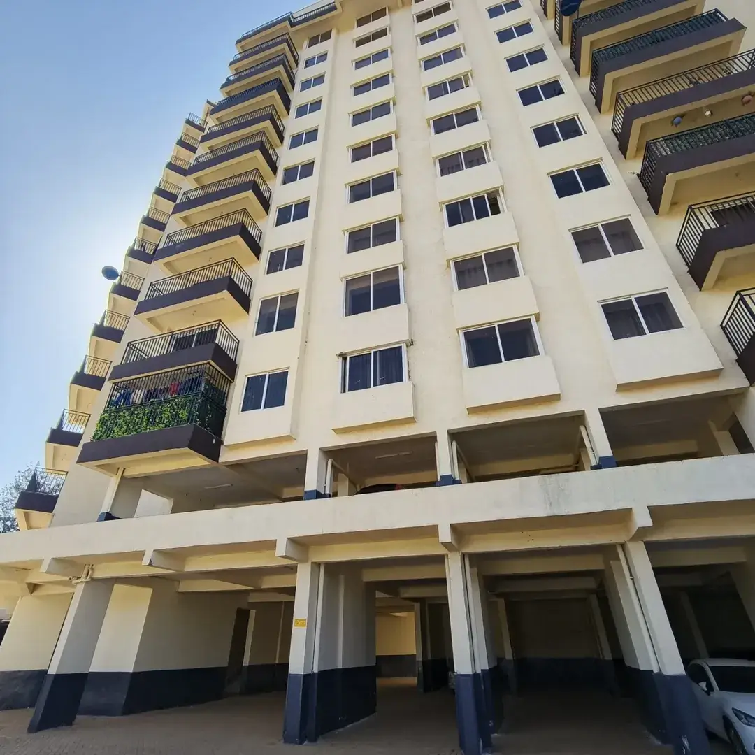 Modern residential apartment building with yellow and white facade