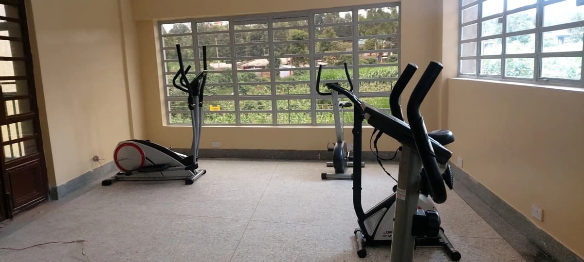 Bright gym room with stationary bikes and exercise equipment