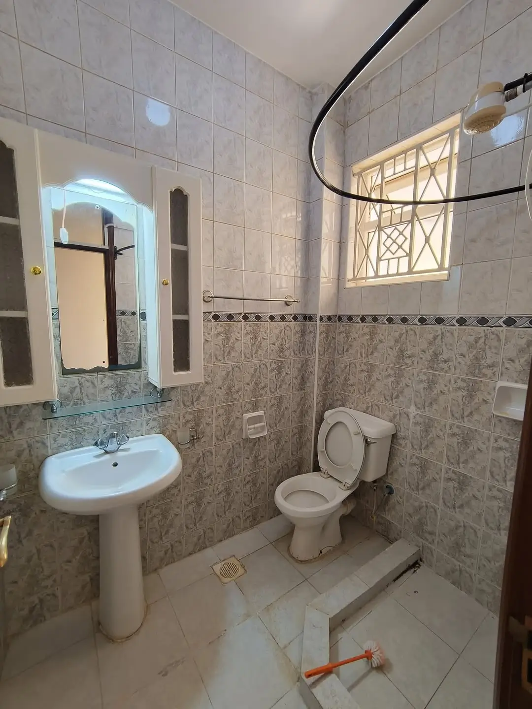 Bathroom with pedestal sink, toilet, and shower enclosure
