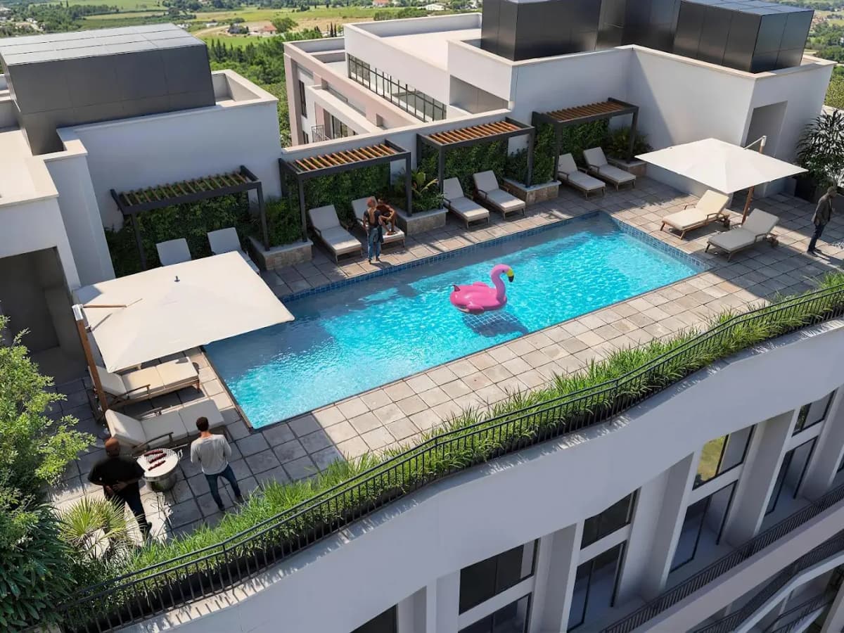 Rooftop infinity pool with sun loungers and pink flamingo float