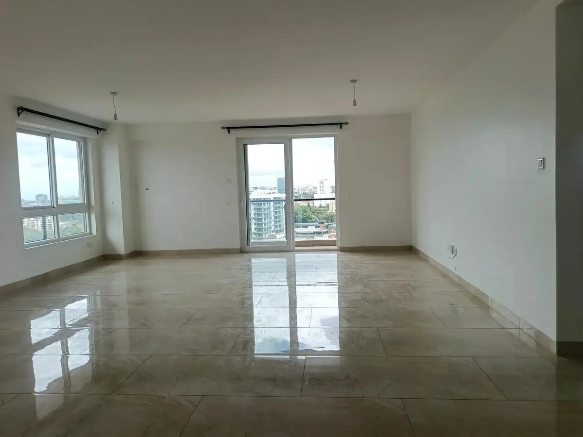 Spacious open-plan living area with polished floors and city views