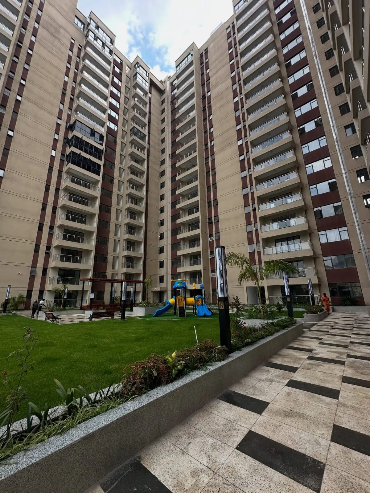 Multi-story residential complex with manicured compound grounds