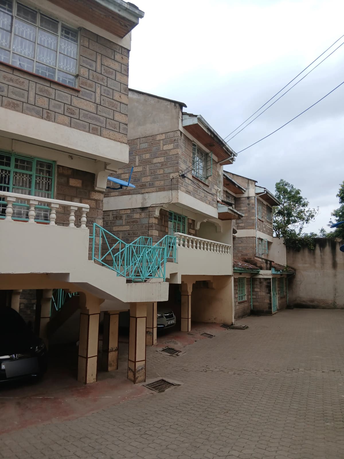 Multi-story residential building with stone facade and balconies