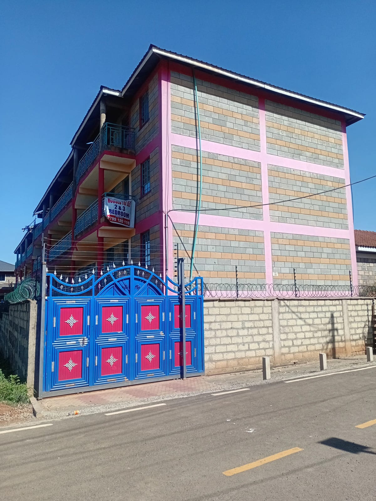 Multi-story residential building with decorative blue gate entrance
