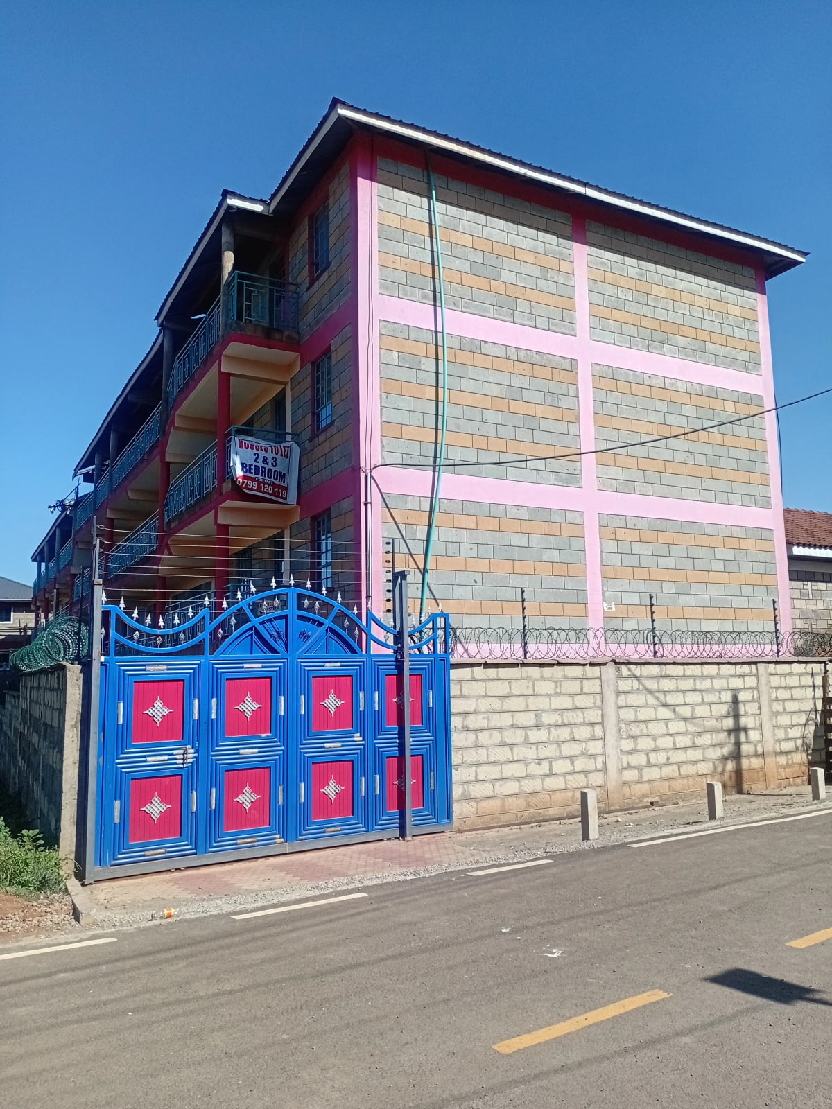 Multi-story residential building with decorative blue gate entrance