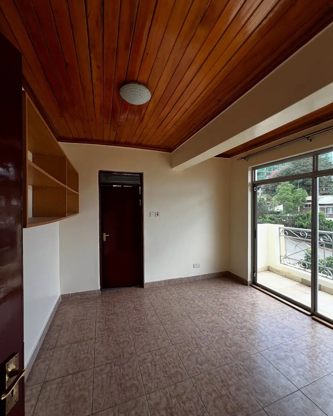 Spacious living room with wooden ceiling and glass doors