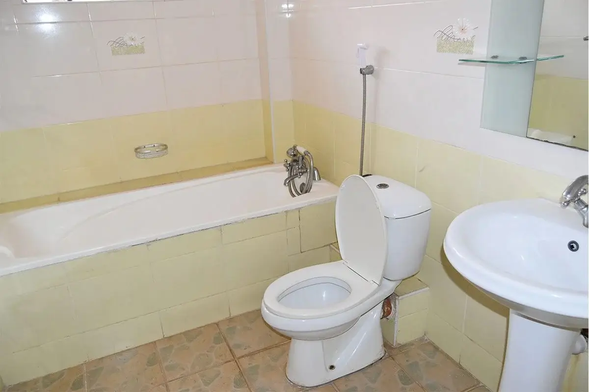 Bathroom with bathtub, toilet, and pedestal sink