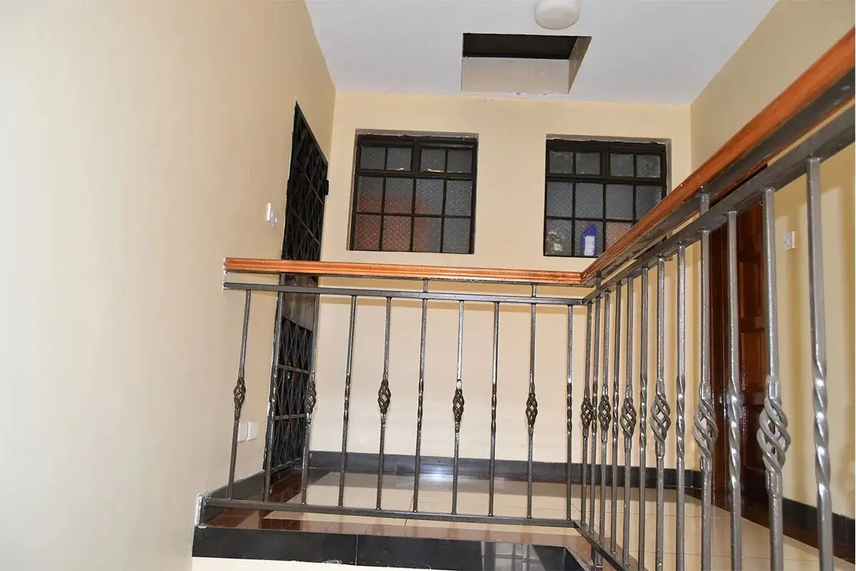 Modern staircase landing with metal railings and natural light