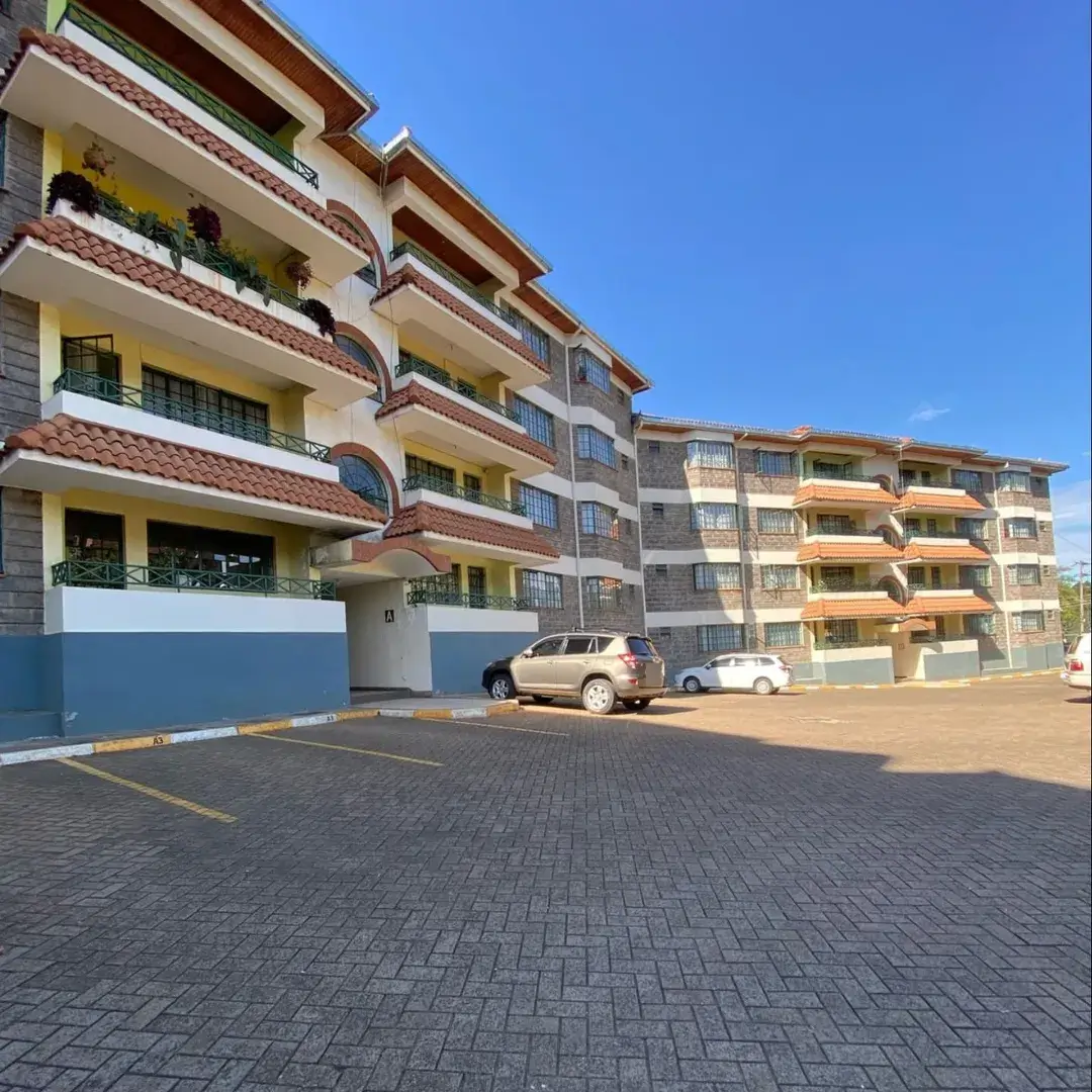 Modern apartment building with paved parking compound entrance