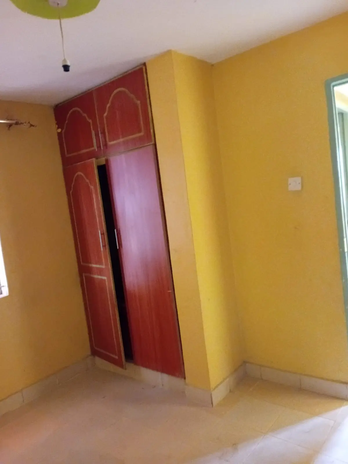 Bright yellow bedroom with red built-in wardrobe
