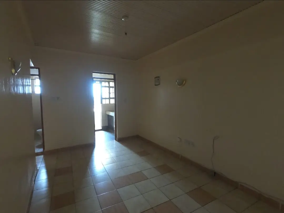 Empty living room with tiled floor and natural light
