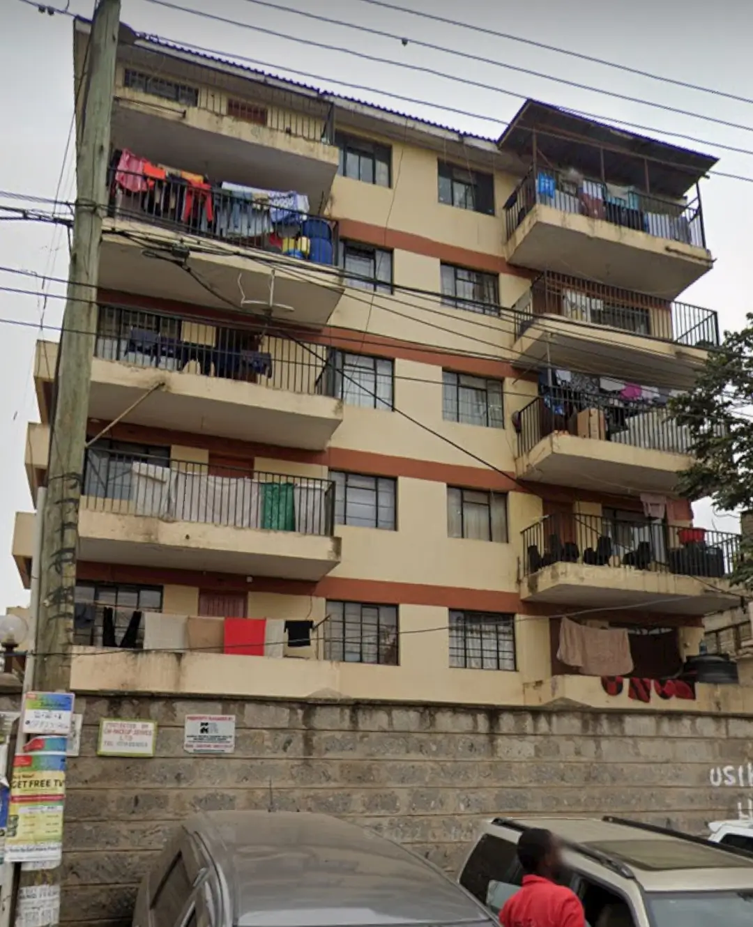 Multi-story residential building facade with balconies and clotheslines