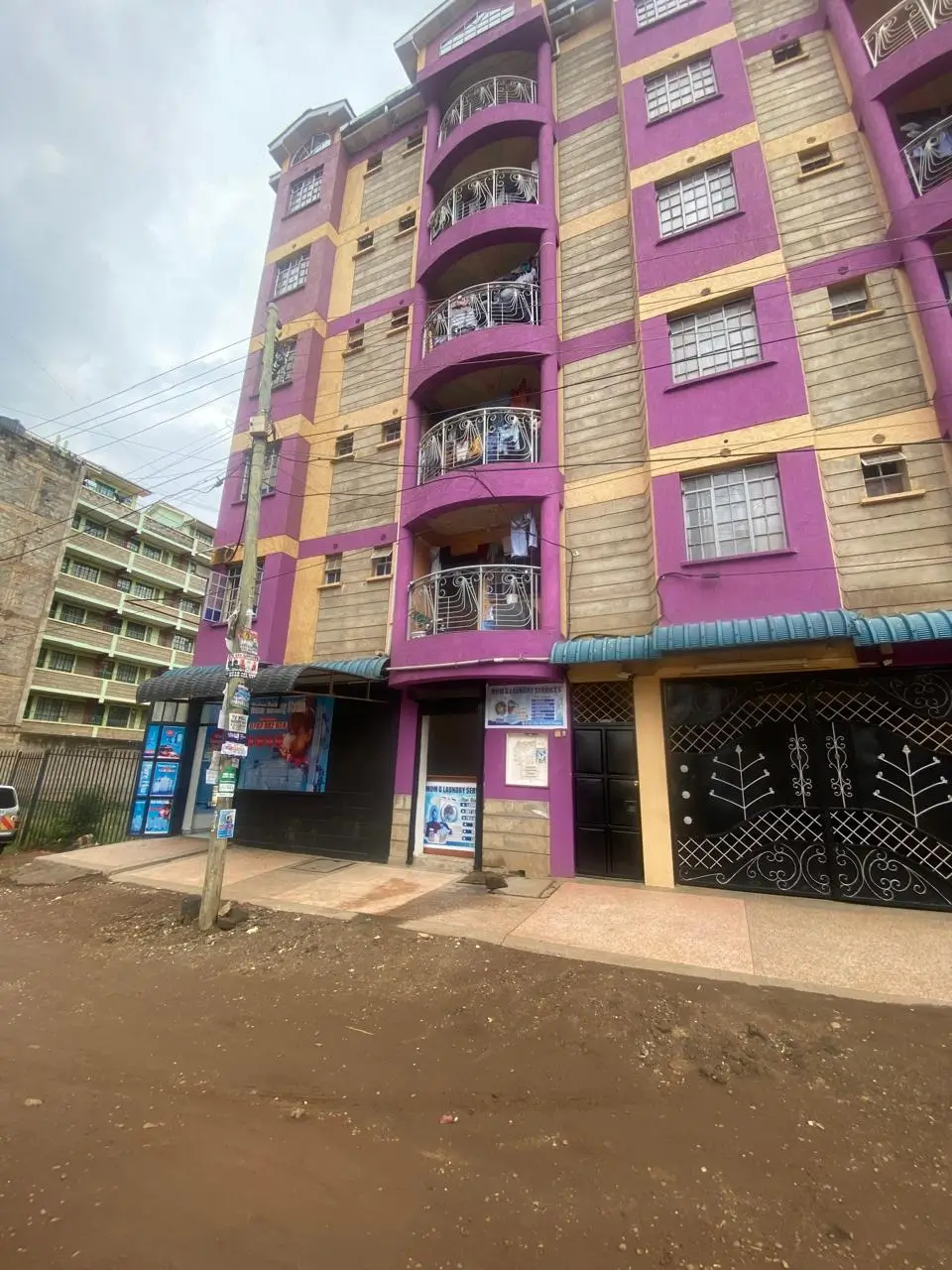 Colorful residential building facade with purple and yellow painted walls