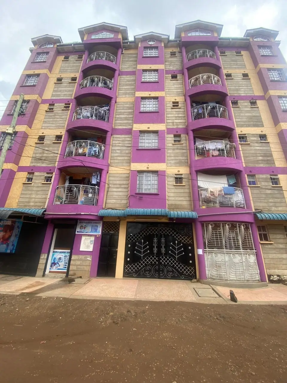 Pink and yellow residential building facade with balconies