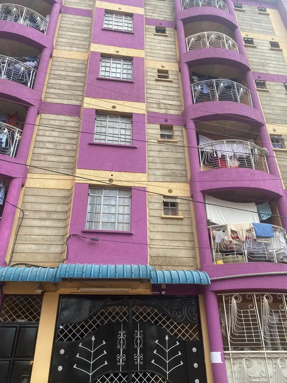 Colorful multi-story residential building facade with curved balconies