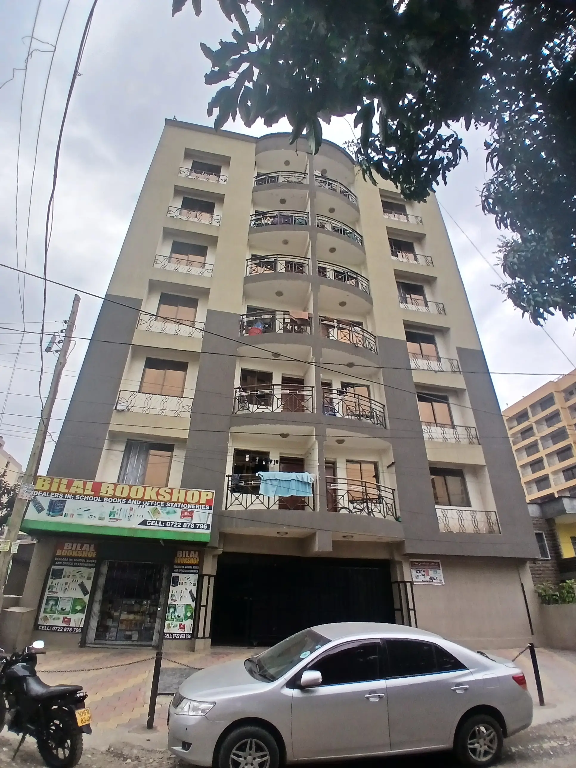 Multi-story residential building facade with ground-floor retail