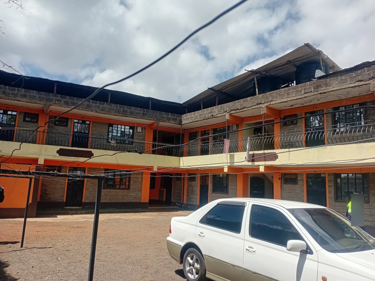 Multi-story orange-painted residential building with central courtyard