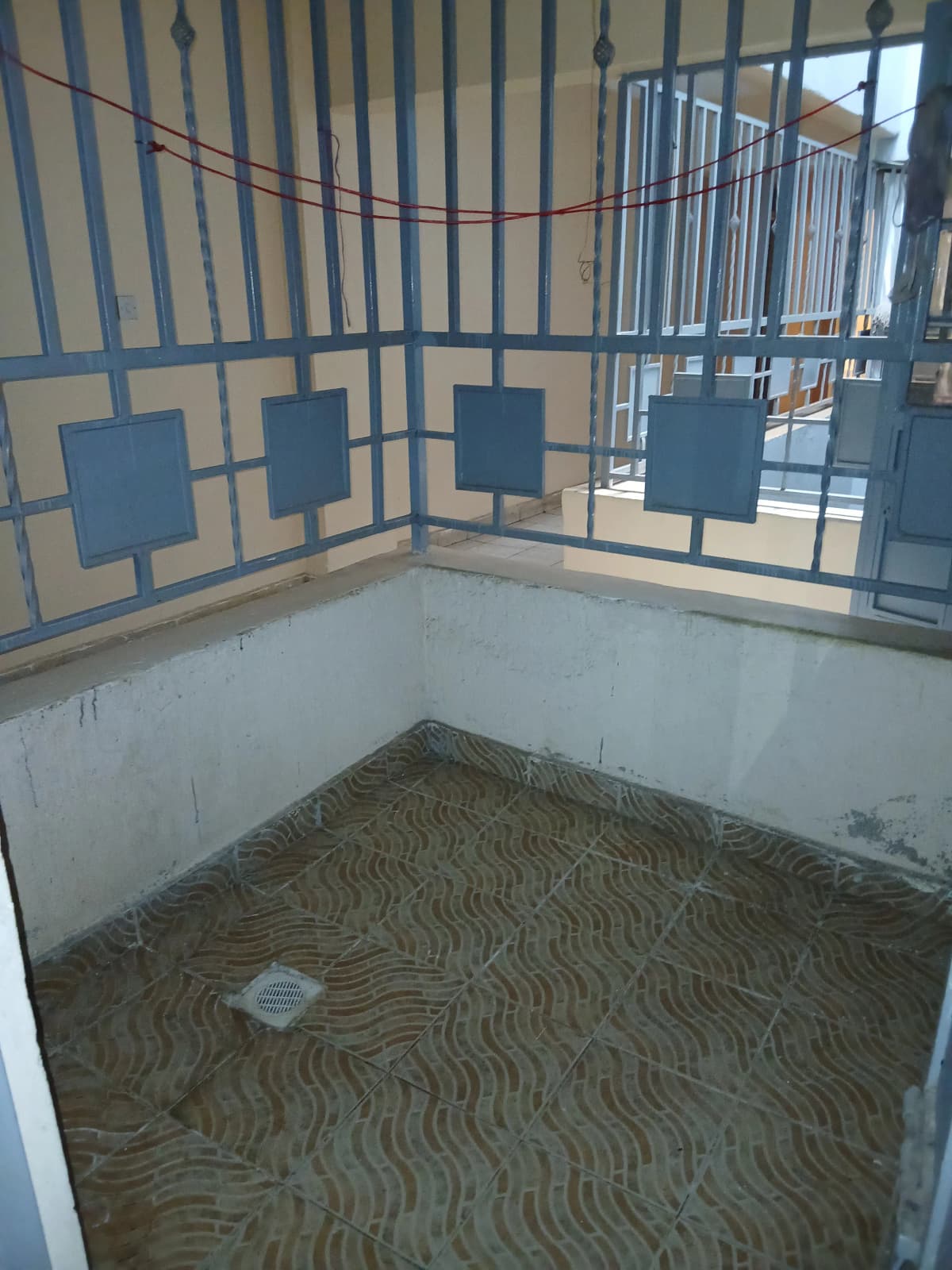 Empty room with patterned flooring and metal railings