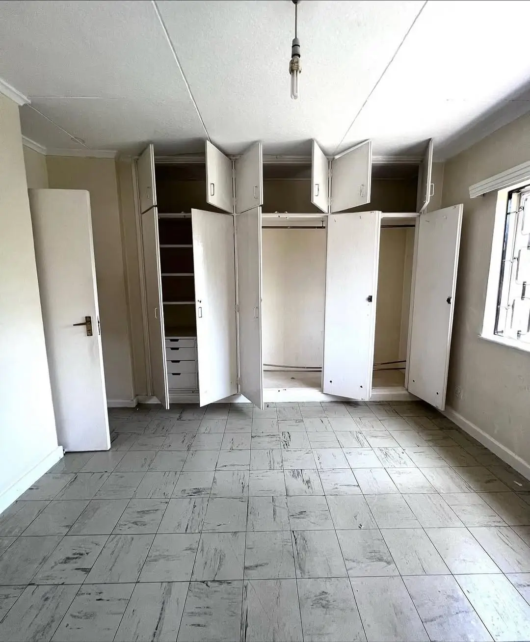 Spacious bedroom with built-in wardrobes and natural light