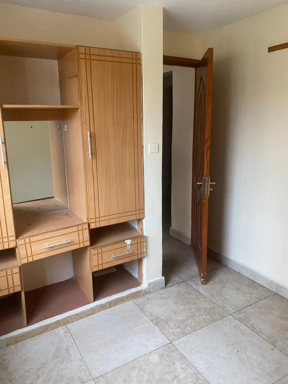 Bedroom with wooden wardrobe and vanity mirror setup