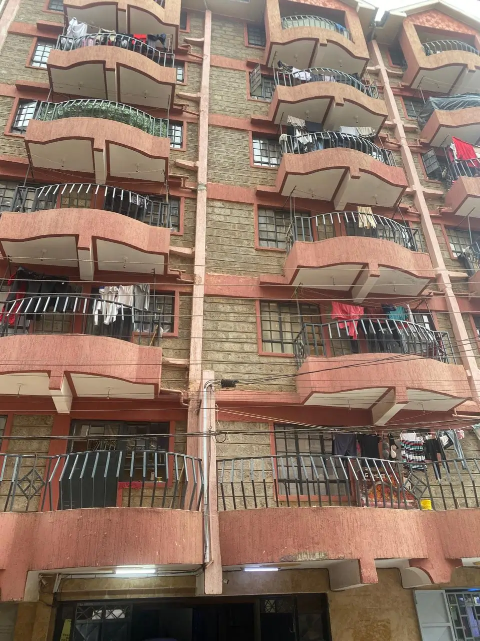 Multi-story residential building facade with balconies and clotheslines
