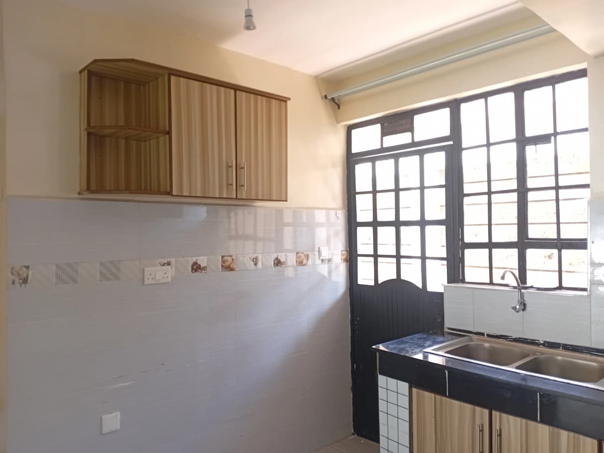 Modern kitchen with wooden cabinets and gridded window